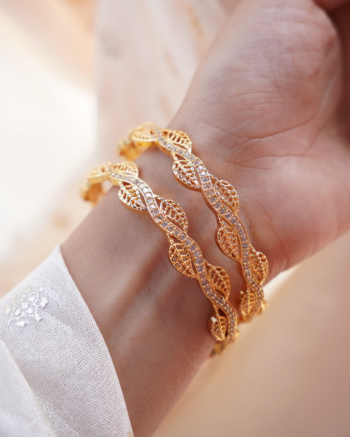 ZORA - Premium 1 Gram Gold Plated Wavy Leaf Bangles | Micro Plated American Diamond Twisted Wave Bracelets Set of 2